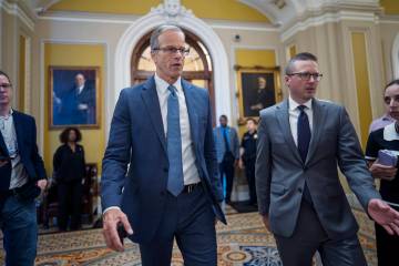 Senate Majority Leader John Thune, R-S.D., rushes from the chamber to his office as he struggle ...