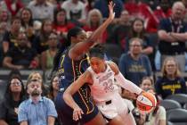 Las Vegas Aces' A'ja Wilson (22) goes to the basket against Indiana Fever's Aliyah Boston (7) d ...